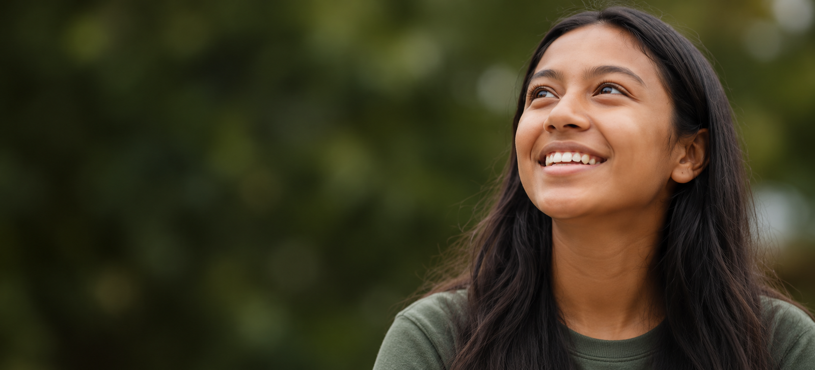 Illustrative portrait of a smiling young woman outdoors
